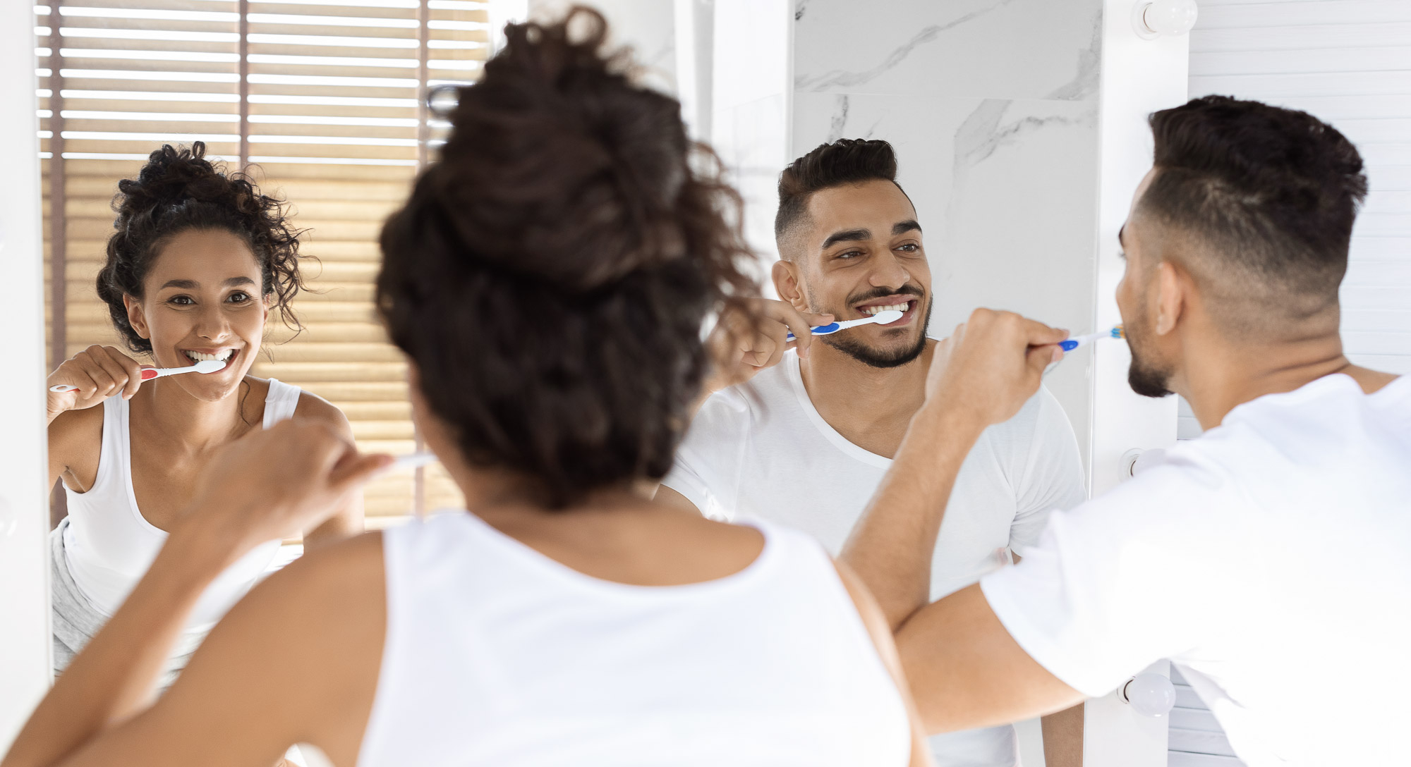 Oral Hygiene. Happy Young Arab Couple Brushing Teeth Together In Bathroom
